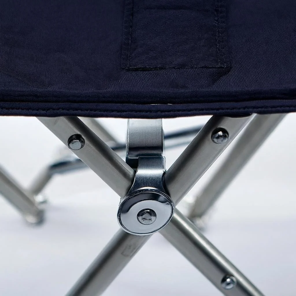 Close-up of aluminum alloy frame joint and riveted hinge mechanism on carp fishing chair